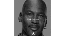 a black and white photo of michael jordan 's face with a quote on his face .