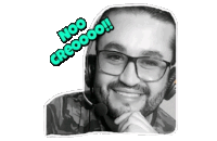 a man wearing glasses and a headset has a sticker on his face that says noo creoooo