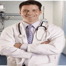 a doctor with his arms crossed and a stethoscope around his neck smiles for the camera