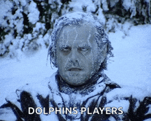 a man with ice on his face and the words dolphins players behind him