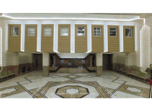 a lobby with a geometric pattern on the floor and a counter