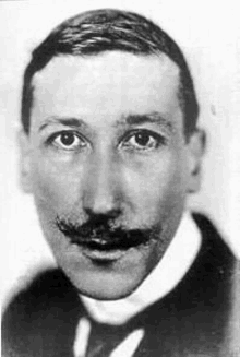 a black and white photo of a man with a mustache and a tie .