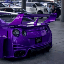 a purple sports car with a license plate that says ' coyote ' on it