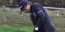 a boy wearing a black jacket with the word greenfields on the sleeve