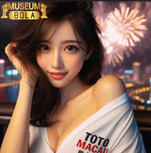 a woman wearing a toto macau shirt stands in front of a fireworks display