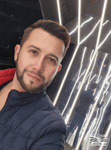 a man taking a selfie in front of a wall that says eye color change real