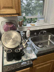 a kitchen counter with a sink and a soap dispenser