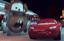 lightning mcqueen and mater from cars are standing next to each other in a gas station .