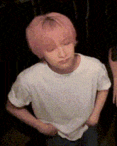 a person with pink hair wearing a white shirt