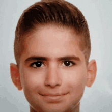 a close up of a young boy 's face with a smile