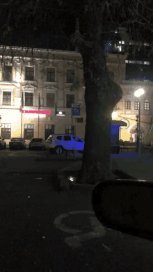 a white suv is parked in front of a building with a sign that says doha