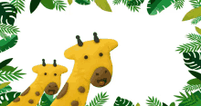 two stuffed giraffes are surrounded by green leaves