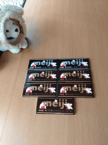 a stack of meiji milk chocolate bars on a wooden table