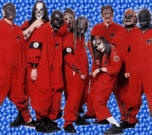 a group of people wearing red jumpsuits and masks are standing together