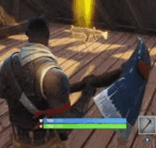 a man is holding a large axe in a video game while laying on a wooden floor .