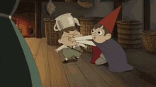 a boy in a witch hat is holding a pot over another boy 's head