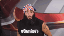 a man with a beard is wearing a black shirt that says #demboys