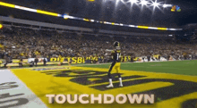 a football player in a pittsburgh steelers uniform stands on a field with the words touchdown written in the foreground