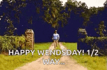 a man is walking down a dirt road with the words `` happy wednesday 1/2 way ... ''