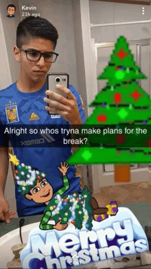 a man taking a selfie in front of a merry christmas sticker