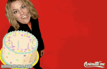 britney spears is holding a birthday cake with candles and says happy birthday