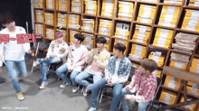 a group of young men are sitting in front of a wall of bookshelves with the name tenor-teumae on the bottom