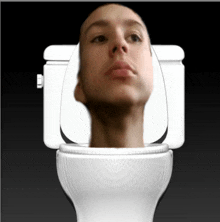 a man 's head is visible in a toilet seat