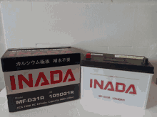 two inada batteries sit next to each other on a table