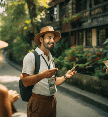 a man wearing a hat has a lanyard around his neck that says ' a ' on it