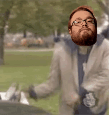 a man with a beard wearing glasses and a watch