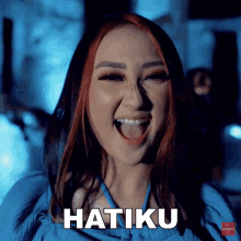 a woman with red hair is making a funny face and the word hatiku is above her mouth