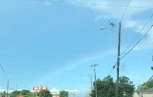 a h-e-b sign is on the side of a street