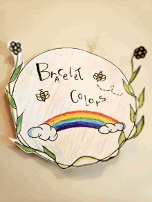 a child 's drawing of a rainbow with the words " brelet colors " on it