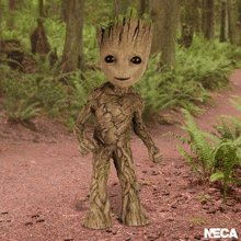 a statue of groot from the movie guardians of the galaxy standing in the woods