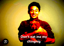 a man holding a dog with the words " do n't eat me my chingnig "