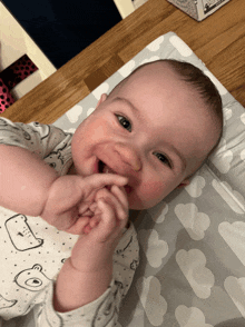 a baby is laying on a changing mat with a box in the background that says ' baby ' on it