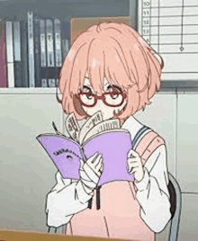 a girl is reading a book in a classroom while wearing glasses .