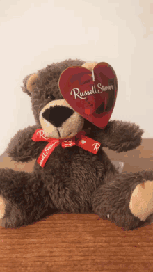 a brown teddy bear with a tag that says russell stevens on it