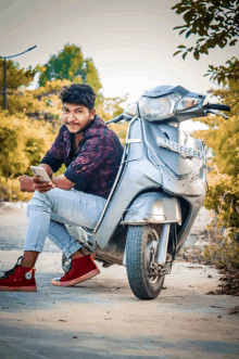 a young man sits on a scooter with a license plate that says t15euf08