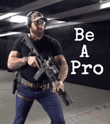 a man holding a rifle in front of a sign that says " be a pro "