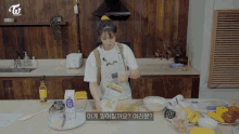 a woman in an apron is preparing food in a kitchen with twice written on the bottom of the screen