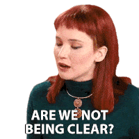 a woman with red hair is wearing a green turtleneck and necklace and says " are we not being clear "