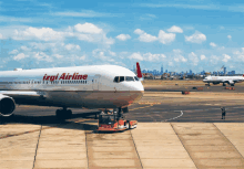 an izgi airline plane is parked on the tarmac at an airport