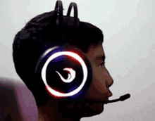 a young boy wearing a pair of headphones with a microphone attached to it