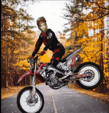 a person riding a dirt bike with a sticker that says ' rsr ' on it