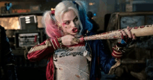 harley quinn is wearing a daddy 's monster shirt and holding a bat