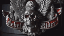 a belt buckle with a skull and an eagle and the words rebel rider on it