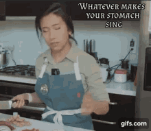 a woman in an apron is preparing food in a kitchen with a caption that says whatever makes your stomach sing