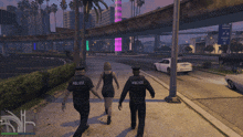 three police officers are walking down a street with a woman in a black dress