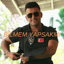 a man wearing sunglasses and a shirt that says bilmem yapsakmi on it